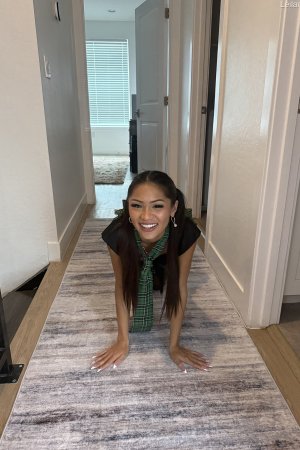 Leilani FTV poses in pigtails and skirt on pink rug photo 10